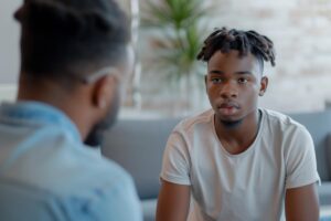 teenage boy talking to mental health professional about what to expect in a trauma therapy program